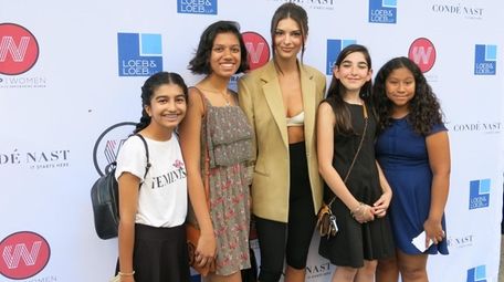 Kidsday reporters pose for a photo with model