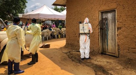 A worker from the World Health Organization decontaminates