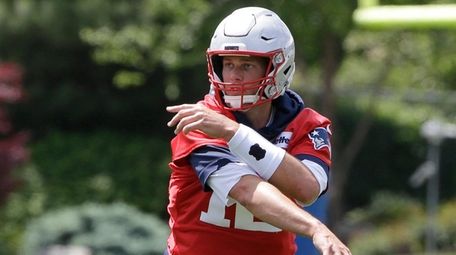 Patriots quarterback Tom Brady follows through on a