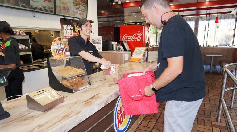 Burger King employee Carlos Urrutia of Wantagh, left,