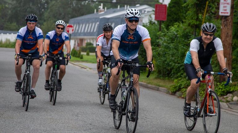 From left, cyclists Michael Simms, of Levittown; Steve