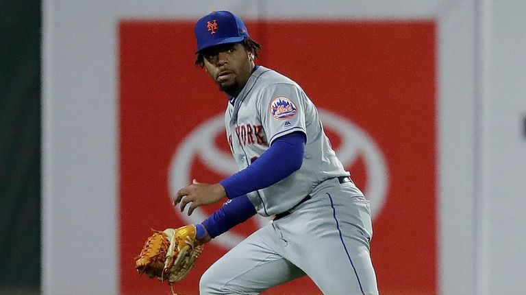 Mets left fielder Dominic Smith watches the game