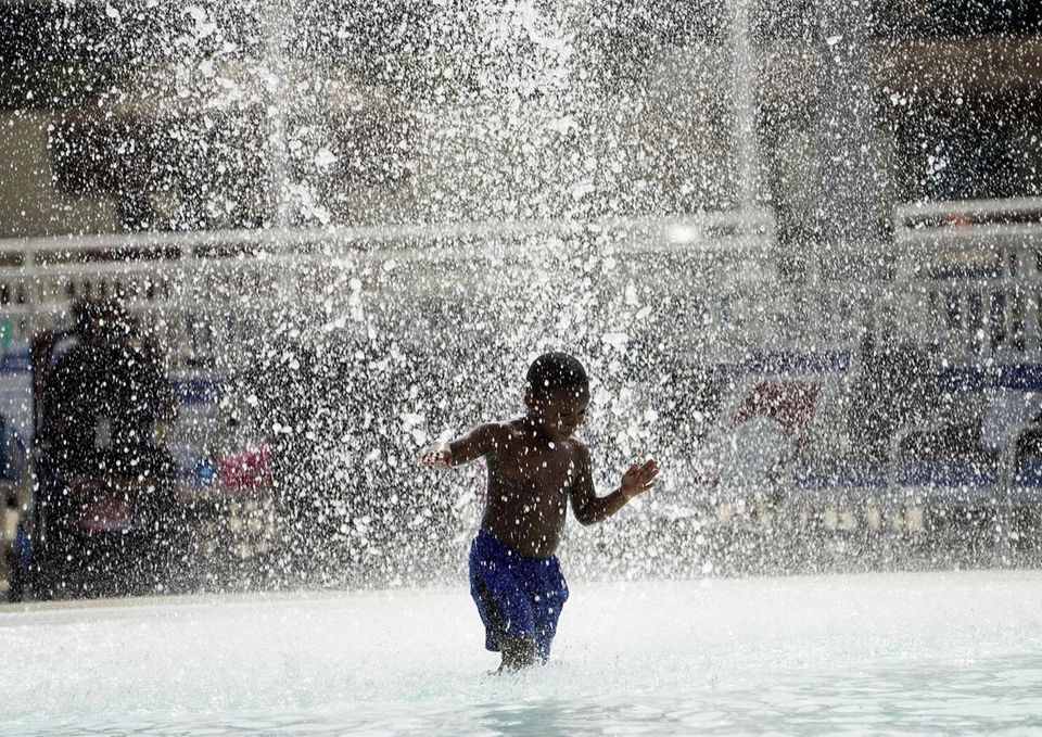 Xavier Stallings, 4, gets relief from the heat