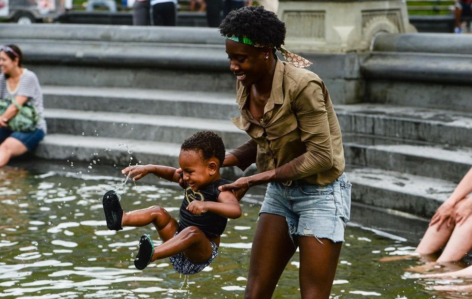 Belle Assata plays with her daughter in the