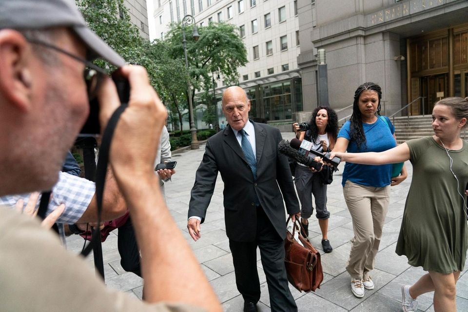 Defense attorney Martin G. Weinberg, center, exits a