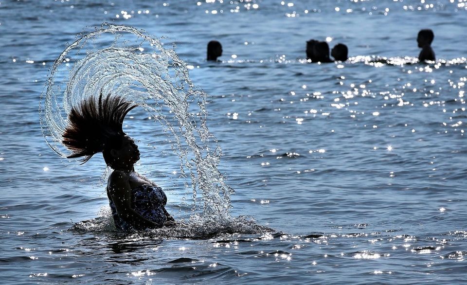 Beachgoer Blanca Menendez flings her hair through the