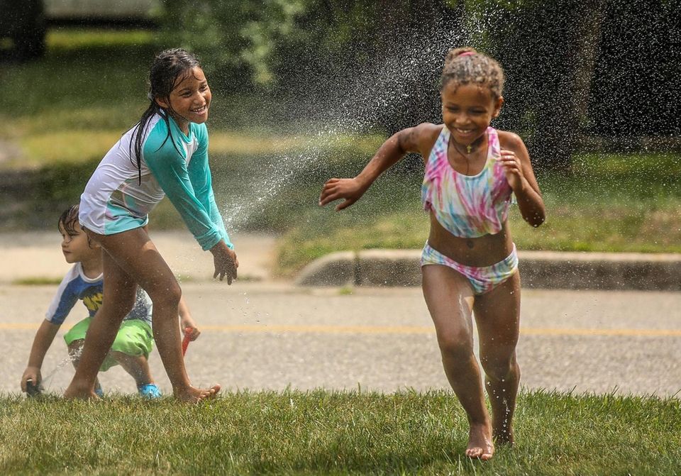 On a hot afternoon, Demi Henthorne, 6, left,