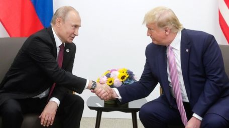 Russian President Vladimir Putin shaking hands with