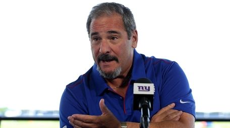 Giants general manager Dave Gettleman talks to the