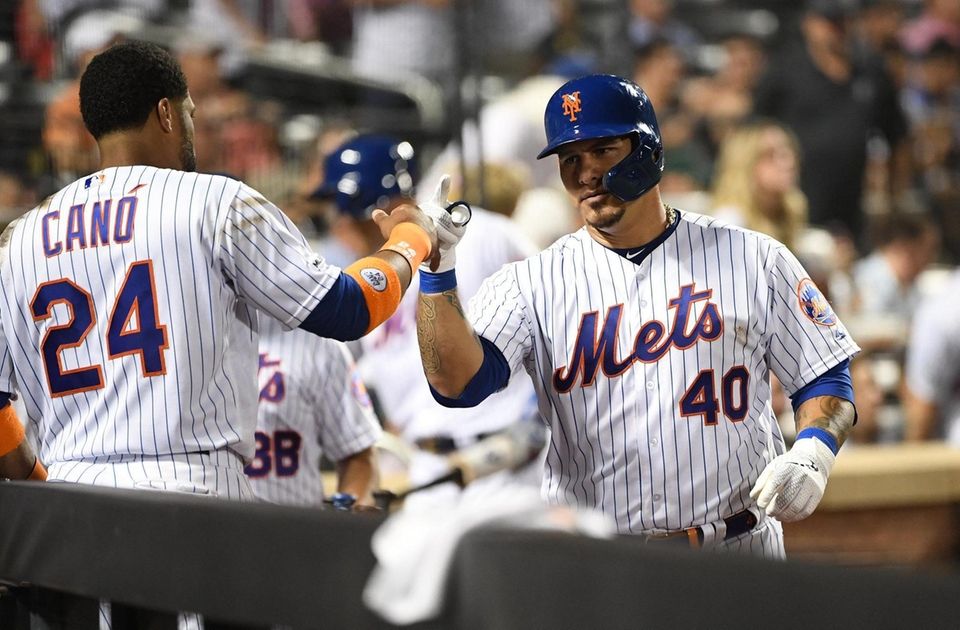 New York Mets catcher Wilson Ramos is greeted