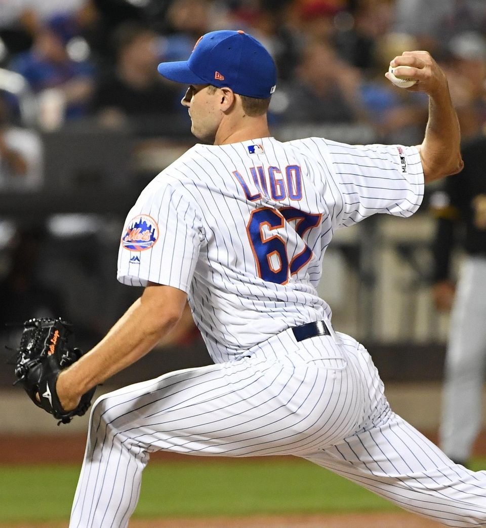 New York Mets relief pitcher Seth Lugo delivers