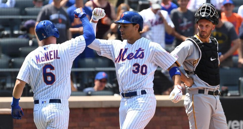 New York Mets' Michael Conforto, center, is greeted