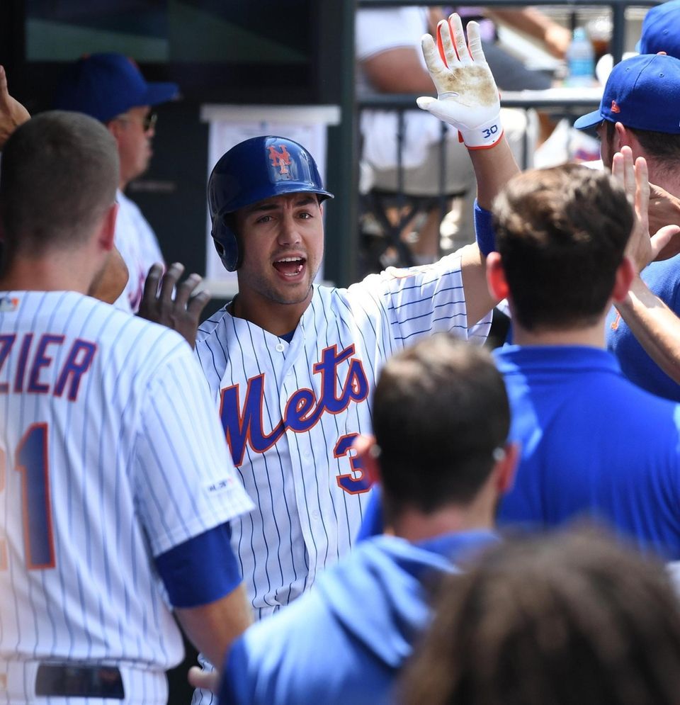 The Mets' Michael Conforto is greeted in the