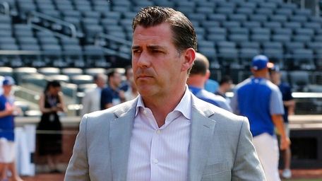 Mets general manager Brodie Van Wagenen stands on