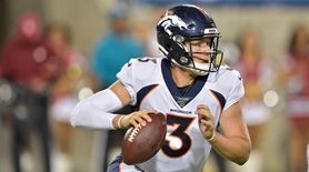 Denver Broncos quarterback Drew Lock scrambles during the