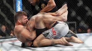 Jim Miller, left, applies the guillotine choke hold