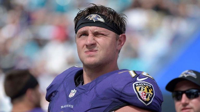 Ravens offensive guard Alex Lewis watches from the