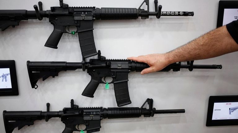 AR-15 rifles are displayed on the exhibit floor