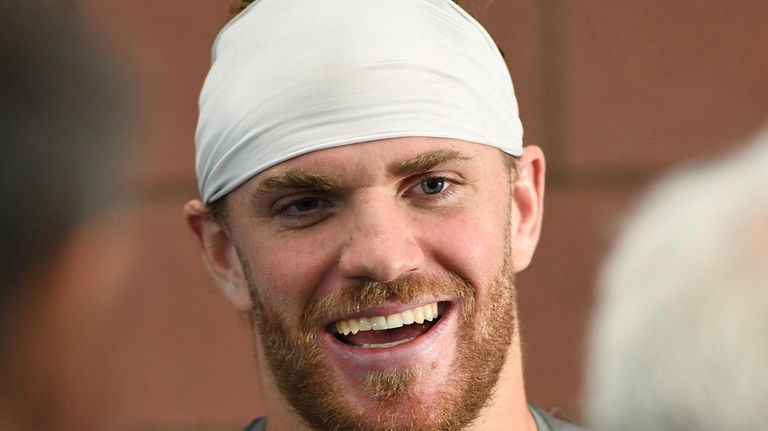 Giants defensive back Jake Carlock answers questions from
