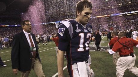 New England Patriots quarterback Tom Brady walks off