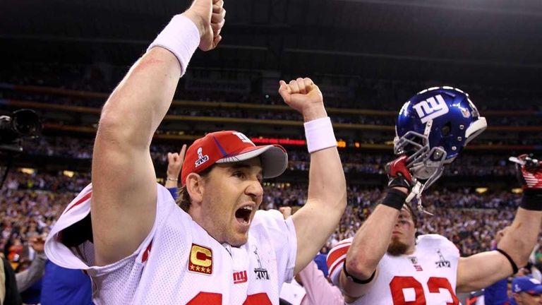 Giants quarterback Eli Manning reacts after watching the