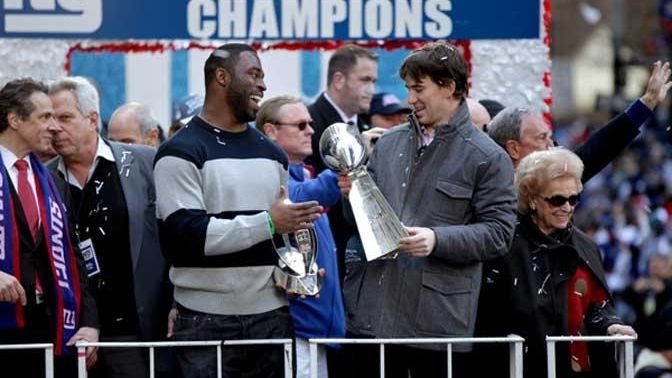 NY Giant's Justin Tuck (L) smiles as he