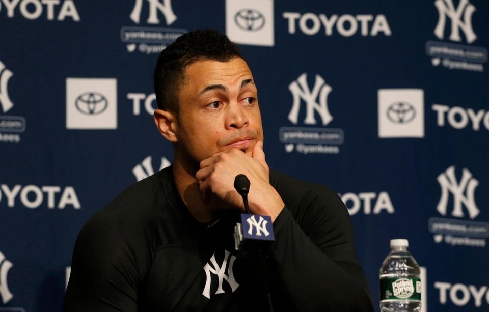 Giancarlo Stanton speaks to reporters before the Yankees'