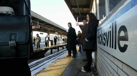 People wait for trains at the Hicksville LIRR