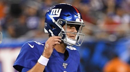 Giants quarterback Daniel Jones runs off the field