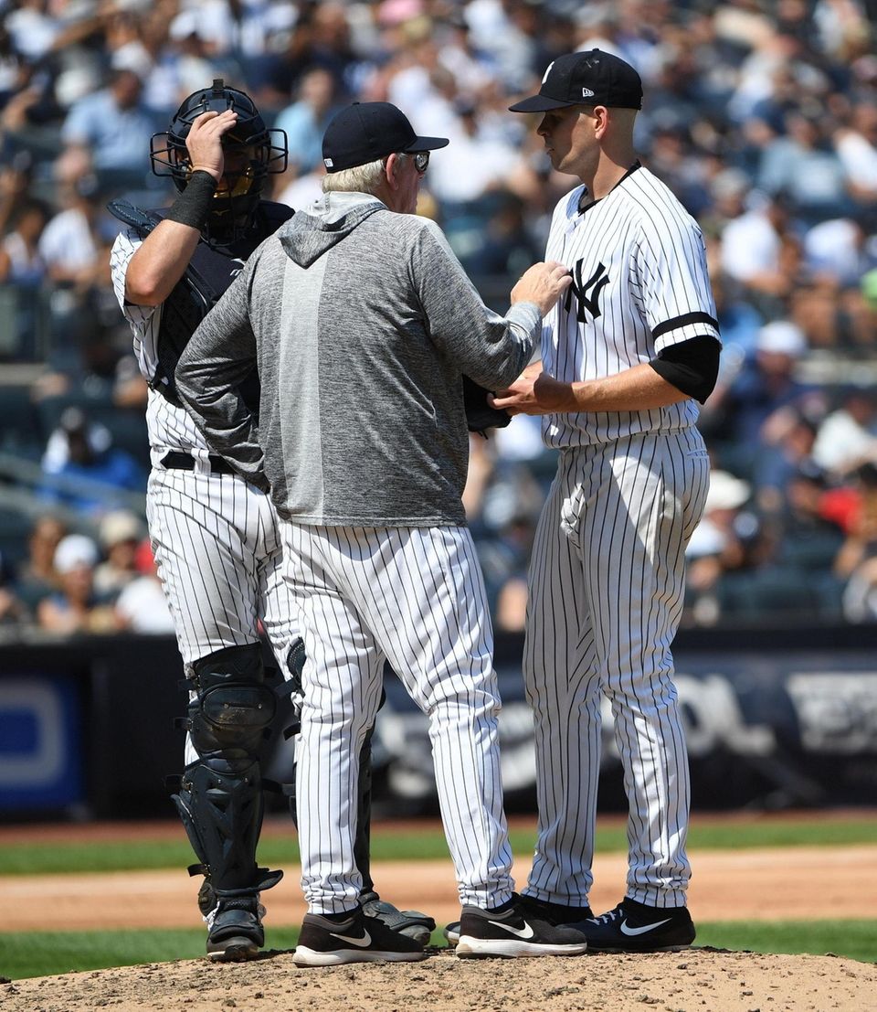 Yankees pitching coach Larry Rothschild talks to starting