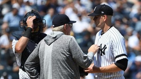 Yankees pitching coach Larry Rothschild talks to starting