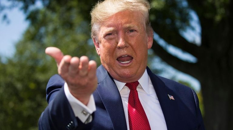 President Donald Trump speaks with reporters on the