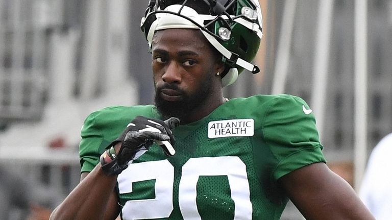 The Jets' Marcus Maye looks on during training