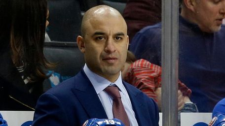 Islanders assistant coach Scott Gomez looks on from