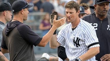DJ LeMahieu is congratulated by Yankees manager Aaron