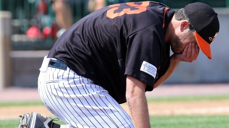 Long Island Ducks starting pitcher Darin Downs holds