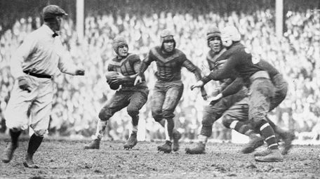 Chicago's Red Grange, left, about to make a