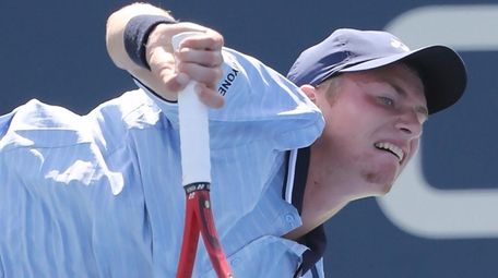 Cannon Kingsley follows through on his serve against