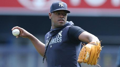Yankees pitcher Luis Severino throws in the outfield