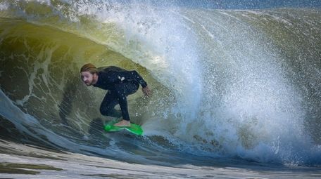 A surfer enjoys the morning light on some