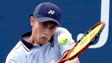 Cannon Kingsley hits the backhand return against Wojciech
