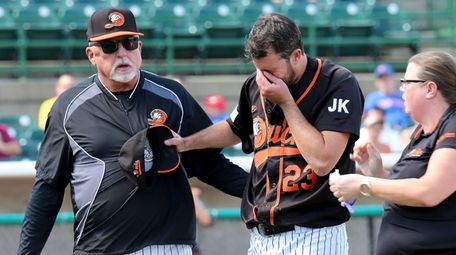 Ducks starting pitcher Darin Downs is escorted off