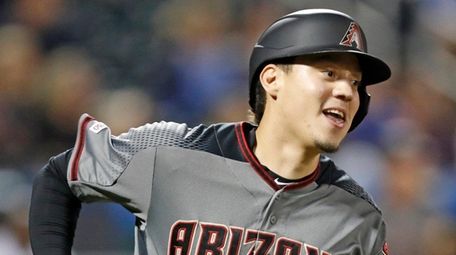 Arizona Diamondbacks' Wilmer Flores runs the bases after