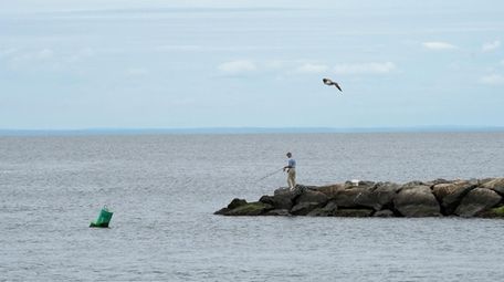 A lone fisherman on the jetties near Mattituck