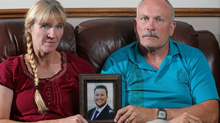Rod and Tonya Meldrum hold a portrait of
