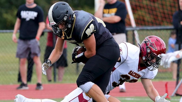 Commack wide receiver Ryan Brady breaks the tackle