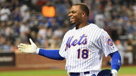Mets' Rajai Davis is greeted at the dugout