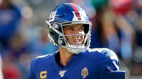 Eli Manning of the Giants looks on after