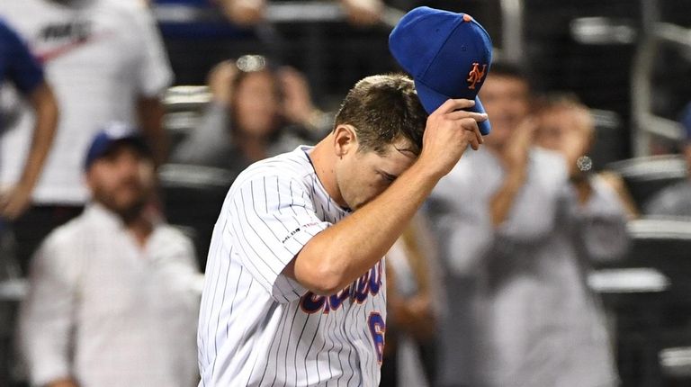 Mets relief pitcher Seth Lugo reacts after the