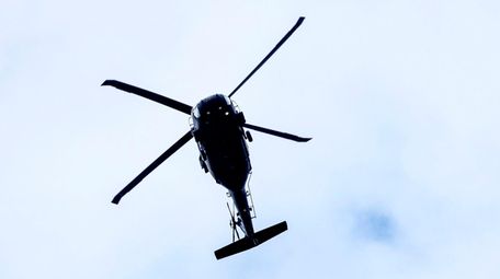 A helicoptor flies over Southold on May 11,